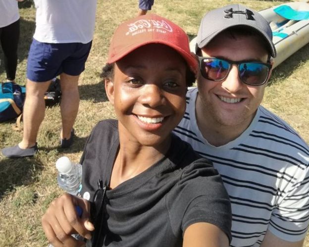 Zanele and Jamie take a selfie in front of a canoe