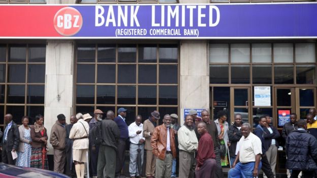 People queue to draw money outside a bank in Harare, Zimbabwe, 15 November 2017