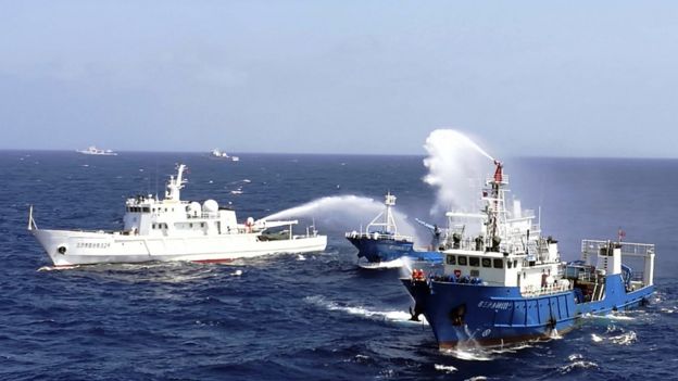 This photo taken on July 14, 2016 shows Chinese ships putting out a fire on a mock cargo vessel during an emergency drill in the South China Sea near Sansha, in south China's Hainan province.