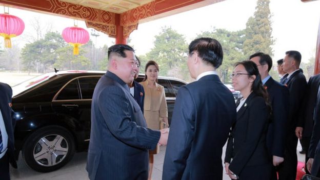 Kim Jong-un stands in front of his Mercedes Benz car in Beijing