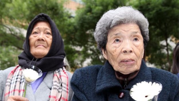 A picture made available 26 December 2015 shows former Philippine comfort woman, Estelita B. Dy (L), and former Taiwan comfort woman, Cheng Chen-tao (R), commemorating deceased comfort women outside Japan