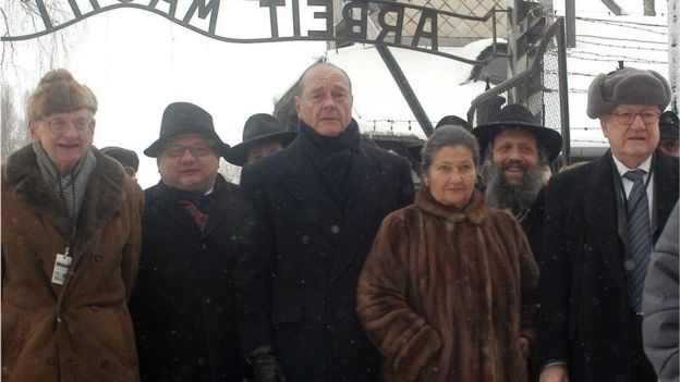 French President Jacques Chirac (3-L), Simone Veil (3-R) and Wladyslaw Bartoszewski (L), both former Auschwitz inmates, walk in front of the gate which carries the infamous 
