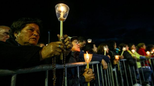 Devotees holding candles participate at the traditional candles procession at Fatima