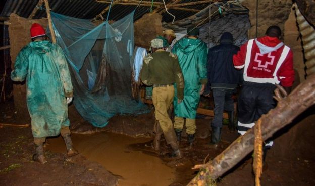 Volunteers search for survivors in a residential area affected by the damburst