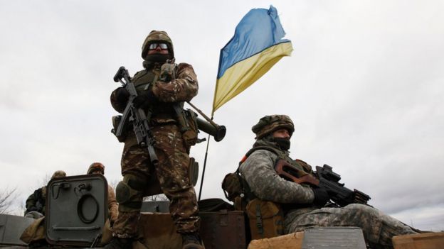 Ukrainian servicemen ride on an armoured personnel carrier at a checkpoint near the eastern Ukrainian town of Debaltseve, Donetsk region, on 24 December 2014