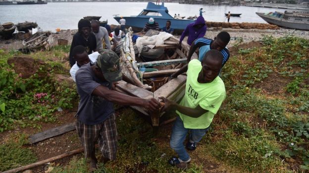 Fishermen move a boat inland as Hurricane Irma approaches Haiti, 7 September 2017