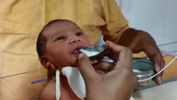 The baby being fed milk