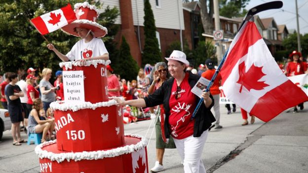 People participate in the East York Toronto Canada Day parade, as the country marks its 150th anniversary with 