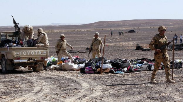 Egyptian army soldiers collect belongings of passengers from the site of crashed Russian jet in Sinai, Egypt on 1 November 2015