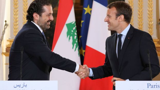 Emmanuel Macron shakes hands with Saad Hariri during a press conference in the Elysee Palace in Paris on September 1, 2017