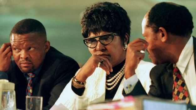 Winnie Madikizela-Mandela and members of her legal team listen to the testimony of one of the witnesses at a special public hearing of South Africa's Truth and Reconciliation Commission in 1997