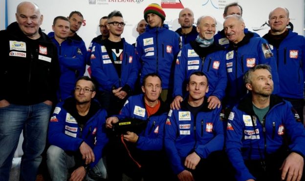 The mountaineers pose for a team photo before their departure for the expedition at an airport in Warsaw, Poland