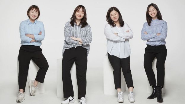 The four female members of Ease & More team pose on stools in promotional image