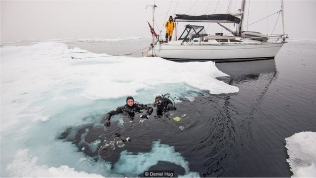The captain and author prepared to dive under the ice