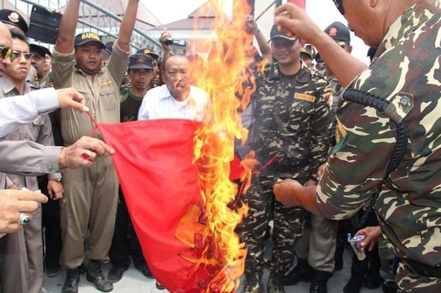 Members of Banser, an organization under Nahdlatul Ulama, burned flags of sickle hammers in Blitar, East Java, September 2015. Banser is referred to as the 'group that executes the communist group'.