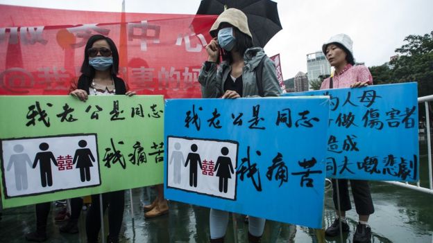 Anti Gay protesters are seen at Victoria Park ahead the Gay Pride Parade in Hong Kong on November 8 2014. The atmosphere was jovial as nearly two thousand people, some wrapped in rainbow-coloured flags and some dressed in drag took to the streets in Hong Kong's Gay Pride parade