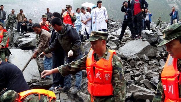 Rescue workers and medical staff search for survivors at landslide site in Xinmo village in Sichuan, southwest China, 24 June 2017