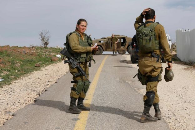 Israeli soldiers block a road in the Israeli-annexed Golan Heights, 10 February 2018