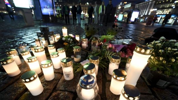 Candles are lit at the scene of the stabbings in Turku
