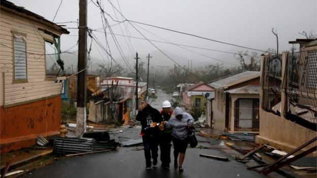 Rescue workers help people after the area was hit by Hurricane Maria in Guayama, Puerto Rico