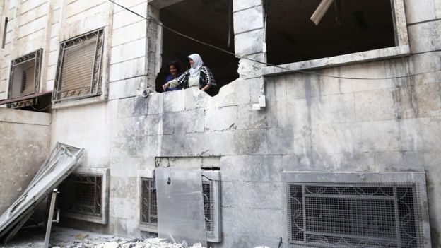 Syrians inspect damage at a psychiatric hospital after it was hit by mortar fire leaving at least one patient killed and over a dozen wounded, in the rebel-held town of Azaz in northern Syria on January 19, 2018.