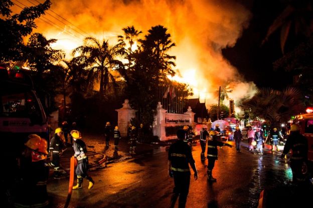Firefighters work at the scene of a fire at Kandawgyi Palace hotel in Yangon early on 19 October 2017