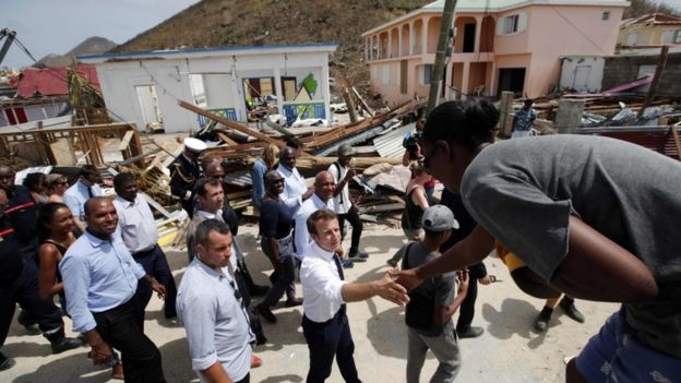 French President Emmanuel Macron shakes hands with residents during a visit to Saint-Martin on 12 September