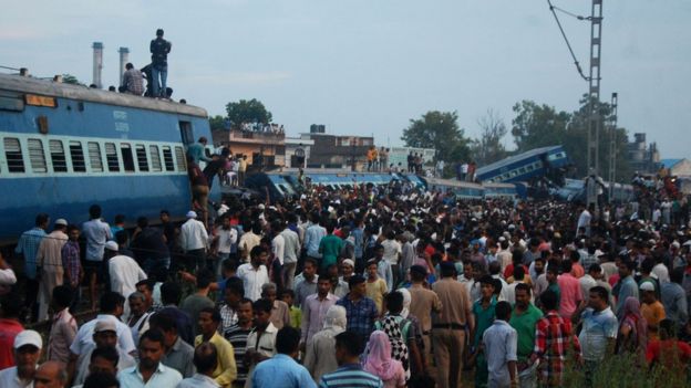 Residentsgather next to carriages after an express train derailed in the Indian state of Uttar Pradesh on August 19, 2017