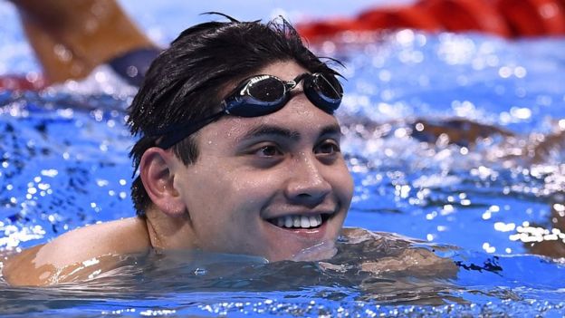 Joseph Schooling smiles after competing in the Men's 100m Butterfly semifinal