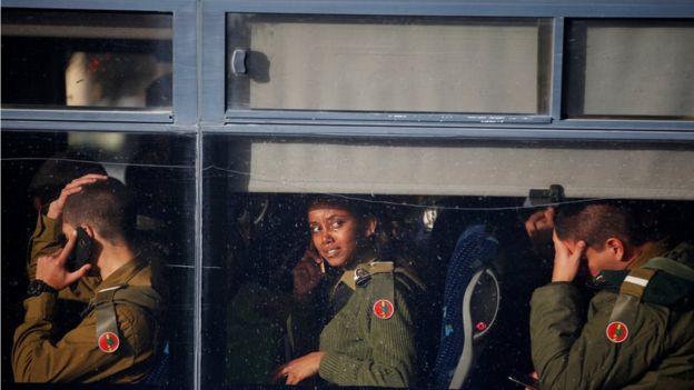 Israeli soldiers sit in a bus as they leave the scene of a truck-ramming incident in Jerusalem January 8, 2017.