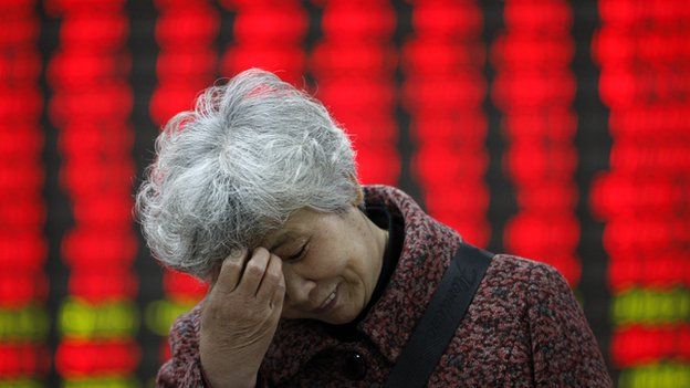 Chinese lady in front of stock price board