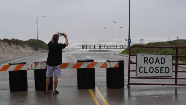 A resident photographs the beach in Corpus Christi