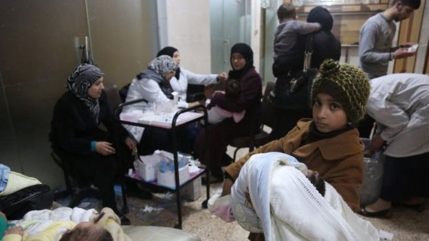 A girl holds her baby sister as they wait for measles vaccinations at a medical centre in the eastern Ghouta area on the outskirts of Damascus (18 March 2017)