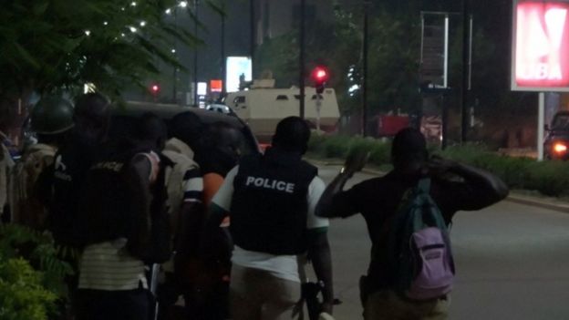 Police are seen on a street following an attack by gunmen on a restaurant in Ouagadougou, Burkina Faso