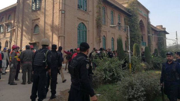 Police and rescue workers stand outside the Directorate of Agriculture Institute in Peshawar, Pakistan 1 December 2017.