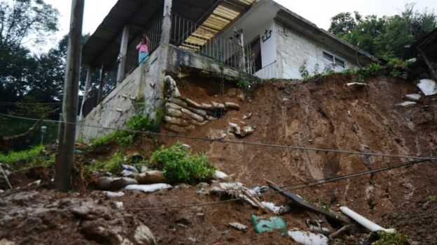 Mudslide with house on top of an embankment