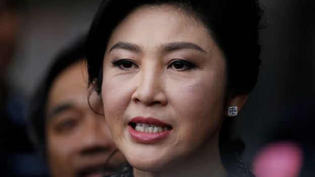 Former Thai prime minister Yingluck Shinawatra speaks to the media as she arrives to deliver closing statements in her trial for alleged criminal negligence over her government