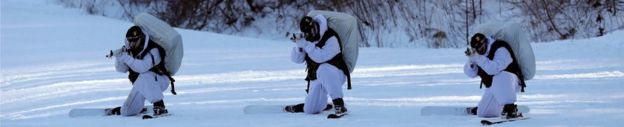 South Korean Marines holding rifles in the snow, while on skis and dressed in white uniforms, in a combined military winter exercise with US Marines in Pyeongchang, South Korea, 24 January 2017.