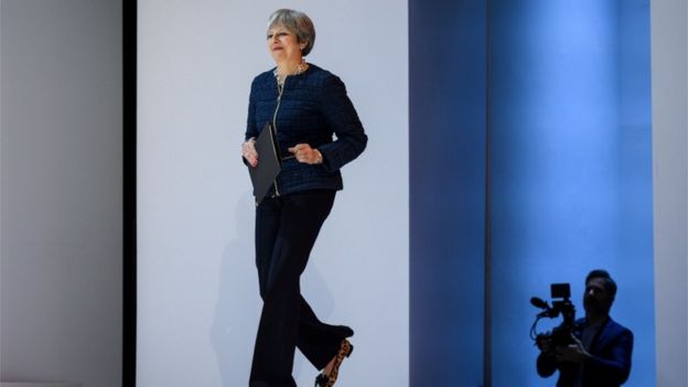 Theresa May walks onto the stage at Davos