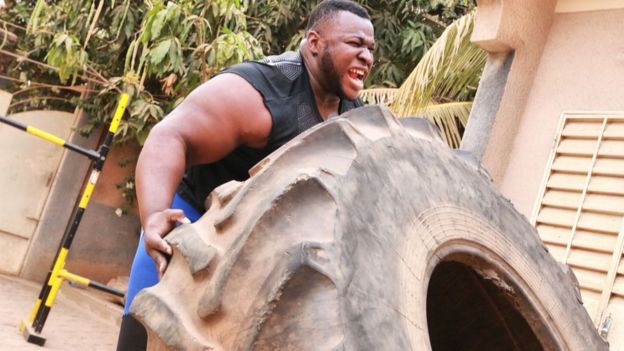 Iron Biby doing tyre flips at his back garden