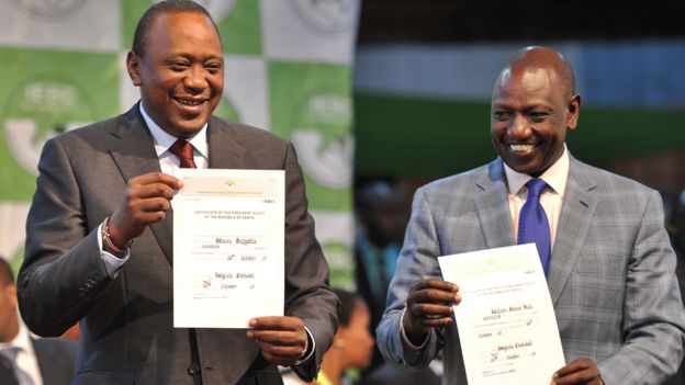 President Kenyatta holds up certificate of election