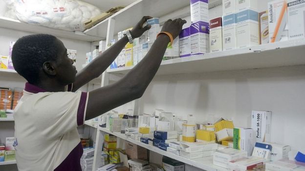 A pharmacist searches for drugs in a pharmacy in Lagos on July 26, 2014. Nigeria was on alert against the possible spread of Ebola on July 26, a day after the first confirmed death from the virus in Lagos.