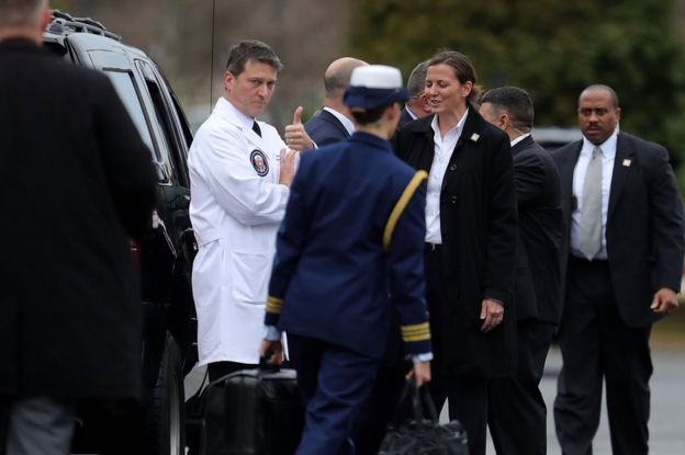 Dr Ronny Jackson gives a thumbs-up after outside Walter Reed National Military Medical Center in Bethesda, Maryland, 12 January 2018