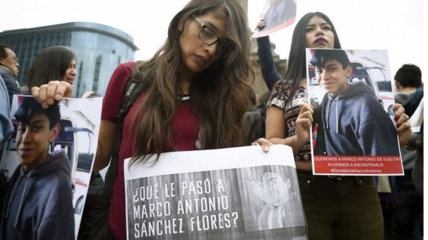 Relatives and students hold posters reading "What happened to Marco Antonio Sanchez?" as they protest against the disappearance of student Marco Antonio Sanchez, at the Angel de la Independencia monument in Mexico City on January 28, 2018
