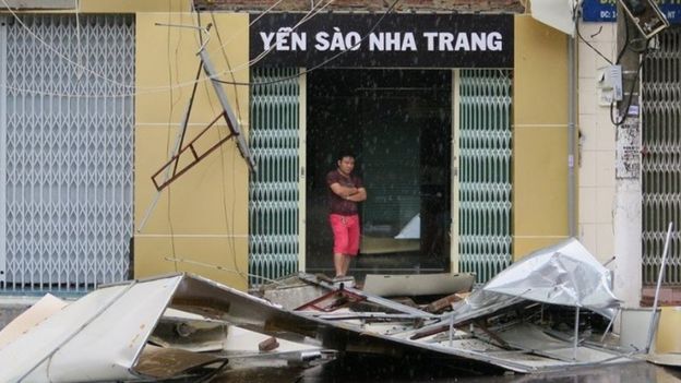 A man stands at a house damaged by Typhoon Damrey, in Nha Trang (04 November 2017)