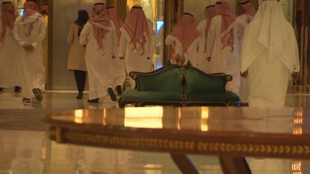 Saudimen in traditional dress are escorted through the Ritz Carlton in Riyadh.