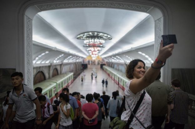 A tourist takes a selfie during a visit to a subway station in Pyongyang on 23 July 2017.