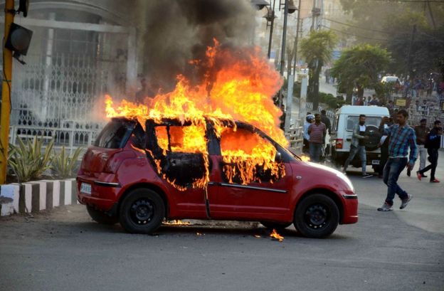 A car burns during a protest against the release of Bollywood movie "Padmavat", in Bhopal on 24 January 2018.