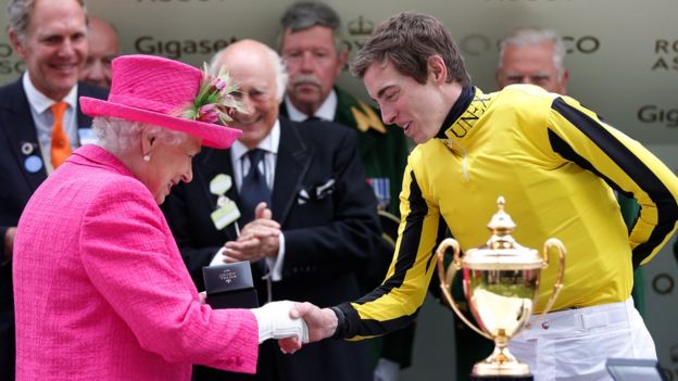 The Queen shaking hands with jockey James doyle
