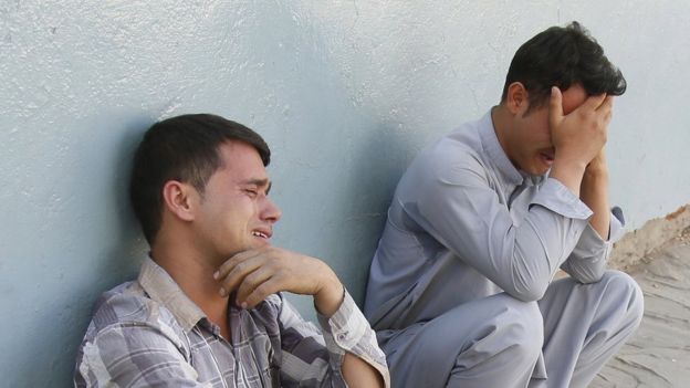 Two young men cry near the scene of the bombing